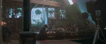 Movie still from “The Sweet Hereafter” (1997), directed by Atom Egoyan – A man sitting on the ground in a room; Wide shot, High angle