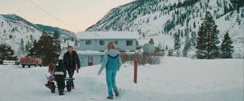 Movie still from “The Sweet Hereafter” (1997), directed by Atom Egoyan – Two people are walking in the snow near a house; Extreme Wide shot, Over the shoulder angle