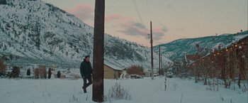 Movie still from “The Sweet Hereafter” (1997), directed by Atom Egoyan – A man standing next to a power pole in the snow; Extreme Wide shot, High angle