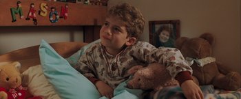 Movie still from “The Sweet Hereafter” (1997), directed by Atom Egoyan – A young boy in pajamas holding a teddy bear; Close Up shot, High angle