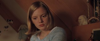 Movie still from “The Sweet Hereafter” (1997), directed by Atom Egoyan – A young woman with long blonde hair wearing a blue sweater; Close Up shot, Over the shoulder angle