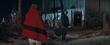 Movie still from “The Sweet Hereafter” (1997), directed by Atom Egoyan – A man holding a guitar in front of a woman; Wide shot, Over the shoulder angle