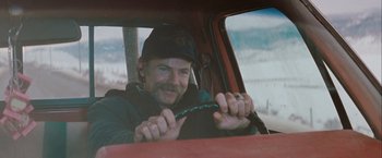 Movie still from “The Sweet Hereafter” (1997), directed by Atom Egoyan – A man sitting in the driver's seat of a truck; Medium shot, Over the shoulder angle