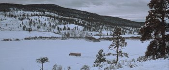 Movie still from “The Sweet Hereafter” (1997), directed by Atom Egoyan – A bus driving through the snow on the side of a mountain; Extreme Wide shot, High angle