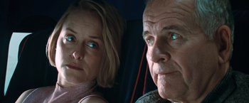 Movie still from “The Sweet Hereafter” (1997), directed by Atom Egoyan – An older man and a younger woman looking at the camera; Close Up shot, Low angle