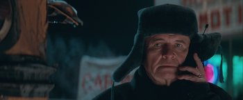 Movie still from “The Sweet Hereafter” (1997), directed by Atom Egoyan – An older man wearing a hat and a cigarette holder; Close Up shot, Low angle