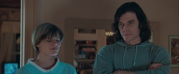 Movie still from “The Sweet Hereafter” (1997), directed by Atom Egoyan – A man and a woman standing next to each other in a living room; Medium shot, Low angle