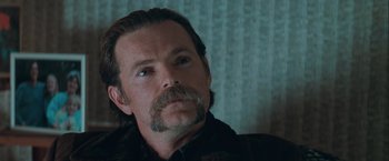 Movie still from “The Sweet Hereafter” (1997), directed by Atom Egoyan – A person with a beard and mustache; Close Up shot, Over the shoulder angle