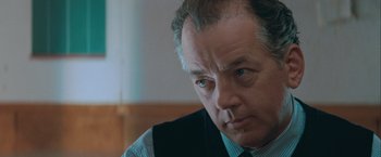 Movie still from “The Sweet Hereafter” (1997), directed by Atom Egoyan – An older man wearing a vest and a tie; Close Up shot, Low angle