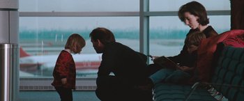 Movie still from “The Sweet Hereafter” (1997), directed by Atom Egoyan – A man and a little girl looking at each other in front of a window; Medium shot, Over the shoulder angle