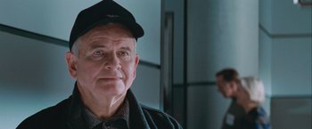Movie still from “The Sweet Hereafter” (1997), directed by Atom Egoyan – An older man wearing a hat and a jacket; Close Up shot, Over the shoulder angle