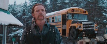 Movie still from “The Sweet Hereafter” (1997), directed by Atom Egoyan – A man standing in front of a school bus; Close Up shot, Over the shoulder angle