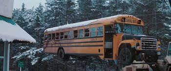 Movie still from “The Sweet Hereafter” (1997), directed by Atom Egoyan – An old school bus parked in the snow; Extreme Wide shot, High angle