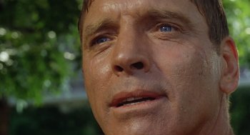 Movie still from “The Swimmer” (1968), directed by Sydney Pollack – A man's face with blue eyes; Close Up shot, Low angle