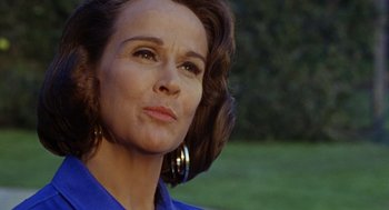 Movie still from “The Swimmer” (1968), directed by Sydney Pollack – A person wearing a blue shirt; Close Up shot, Low angle