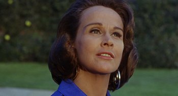 Movie still from “The Swimmer” (1968), directed by Sydney Pollack – A person wearing a blue shirt; Close Up shot, Low angle