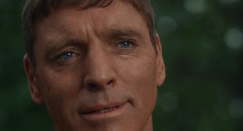 Movie still from “The Swimmer” (1968), directed by Sydney Pollack – A man's face with blue eyes; Extreme Close Up shot, Over the shoulder angle