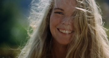 Movie still from “The Swimmer” (1968), directed by Sydney Pollack – A beautiful young lady smiling for the camera; Close Up shot, Low angle