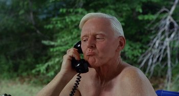 Movie still from “The Swimmer” (1968), directed by Sydney Pollack – An older man with a white hair talking on a black phone; Close Up shot, Low angle