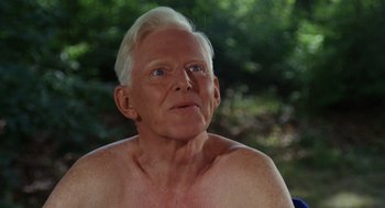 Movie still from “The Swimmer” (1968), directed by Sydney Pollack – An old man with a white hair and blue eyes looking at the camera; Close Up shot, Low angle