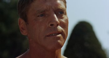 Movie still from “The Swimmer” (1968), directed by Sydney Pollack – A man's face in the sunlight; Close Up shot, Low angle