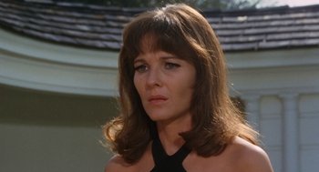 Movie still from “The Swimmer” (1968), directed by Sydney Pollack – A person with long hair; Close Up shot, Low angle