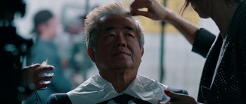 Movie still from “The Switch” (2010), directed by Josh Gordon – An older man getting his hair cut at a barber shop; Close Up shot, Over the shoulder angle