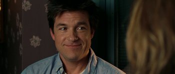 Movie still from “The Switch” (2010), directed by Josh Gordon – A person smiling for the camera; Close Up shot, Over the shoulder angle