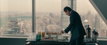 Movie still from “The Switch” (2010), directed by Josh Gordon – A man standing at a table with a tray of food; Medium shot, Over the shoulder angle