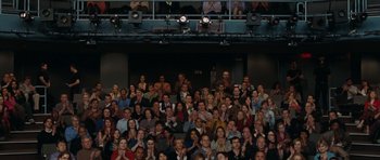 Movie still from “The Switch” (2010), directed by Josh Gordon – A large group of people sitting in front of an audience; Wide shot, High angle