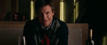 Movie still from “The Switch” (2010), directed by Josh Gordon – A person sitting in a chair wearing a sweater; Close Up shot, Over the shoulder angle