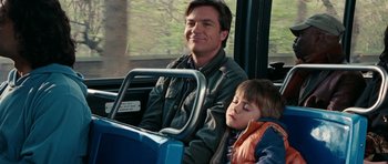 Movie still from “The Switch” (2010), directed by Josh Gordon – A man and a boy riding a bus together; Medium shot, Over the shoulder angle