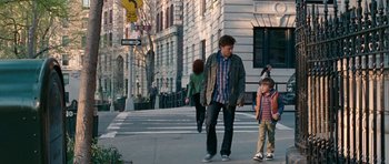 Movie still from “The Switch” (2010), directed by Josh Gordon – A man and a boy cross a street in a city; Wide shot, Over the shoulder angle