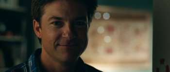 Movie still from “The Switch” (2010), directed by Josh Gordon – A man smiling for the camera; Close Up shot, Low angle