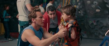 Movie still from “The Switch” (2010), directed by Josh Gordon – A man and a boy are hanging on a rope; Medium shot, Over the shoulder angle