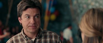 Movie still from “The Switch” (2010), directed by Josh Gordon – A person wearing a plaid shirt; Close Up shot, Over the shoulder angle