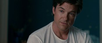 Movie still from “The Switch” (2010), directed by Josh Gordon – A person wearing a white t - shirt; Close Up shot, Over the shoulder angle