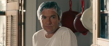 Movie still from “The Switch” (2010), directed by Josh Gordon – A man wearing a head covering and a white shirt; Close Up shot, Over the shoulder angle