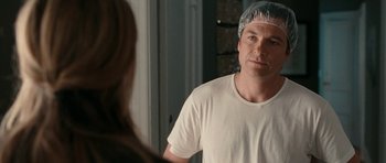 Movie still from “The Switch” (2010), directed by Josh Gordon – A man wearing a surgical cap looking into a mirror; Close Up shot, Over the shoulder angle