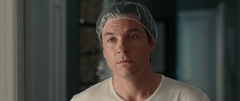 Movie still from “The Switch” (2010), directed by Josh Gordon – A person wearing a hat; Close Up shot, Over the shoulder angle