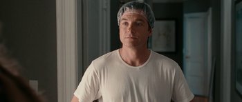 Movie still from “The Switch” (2010), directed by Josh Gordon – A man wearing a white shirt and a plastic hat; Close Up shot, Over the shoulder angle