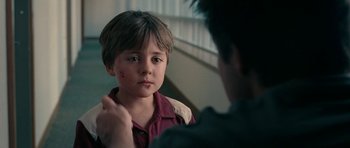 Movie still from “The Switch” (2010), directed by Josh Gordon – A young boy is looking at a younger man; Close Up shot, Over the shoulder angle