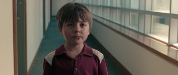 Movie still from “The Switch” (2010), directed by Josh Gordon – A young boy standing in front of a window; Close Up shot, High angle