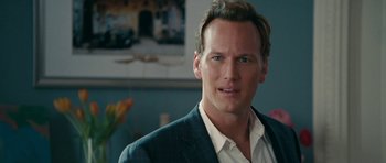 Movie still from “The Switch” (2010), directed by Josh Gordon – A person wearing a suit and tie; Close Up shot, Over the shoulder angle