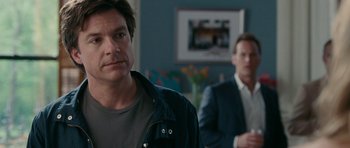 Movie still from “The Switch” (2010), directed by Josh Gordon – A man standing next to another man in front of a mirror; Close Up shot, Over the shoulder angle
