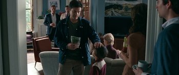 Movie still from “The Switch” (2010), directed by Josh Gordon – A man is helping a young boy with his hair; Medium shot, Over the shoulder angle