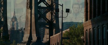Movie still from “The Switch” (2010), directed by Josh Gordon – A picture of a bridge and a building with trees in the background; Extreme Wide shot, Low angle