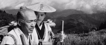 Movie still from “The Sword of Doom” (1966), directed by Kihachi Okamoto – A man and a woman in traditional japanese clothing; Close Up shot, Low angle