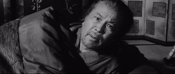Movie still from “The Sword of Doom” (1966), directed by Kihachi Okamoto – An older man with a beard and mustache; Close Up shot, Low angle
