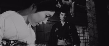 Movie still from “The Sword of Doom” (1966), directed by Kihachi Okamoto – A man and a woman standing next to each other; Medium shot, Over the shoulder angle